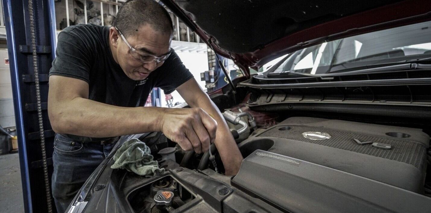 Mechanic Works on Auto Repair